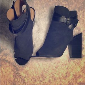 Black peep-toe booties with buckle strap